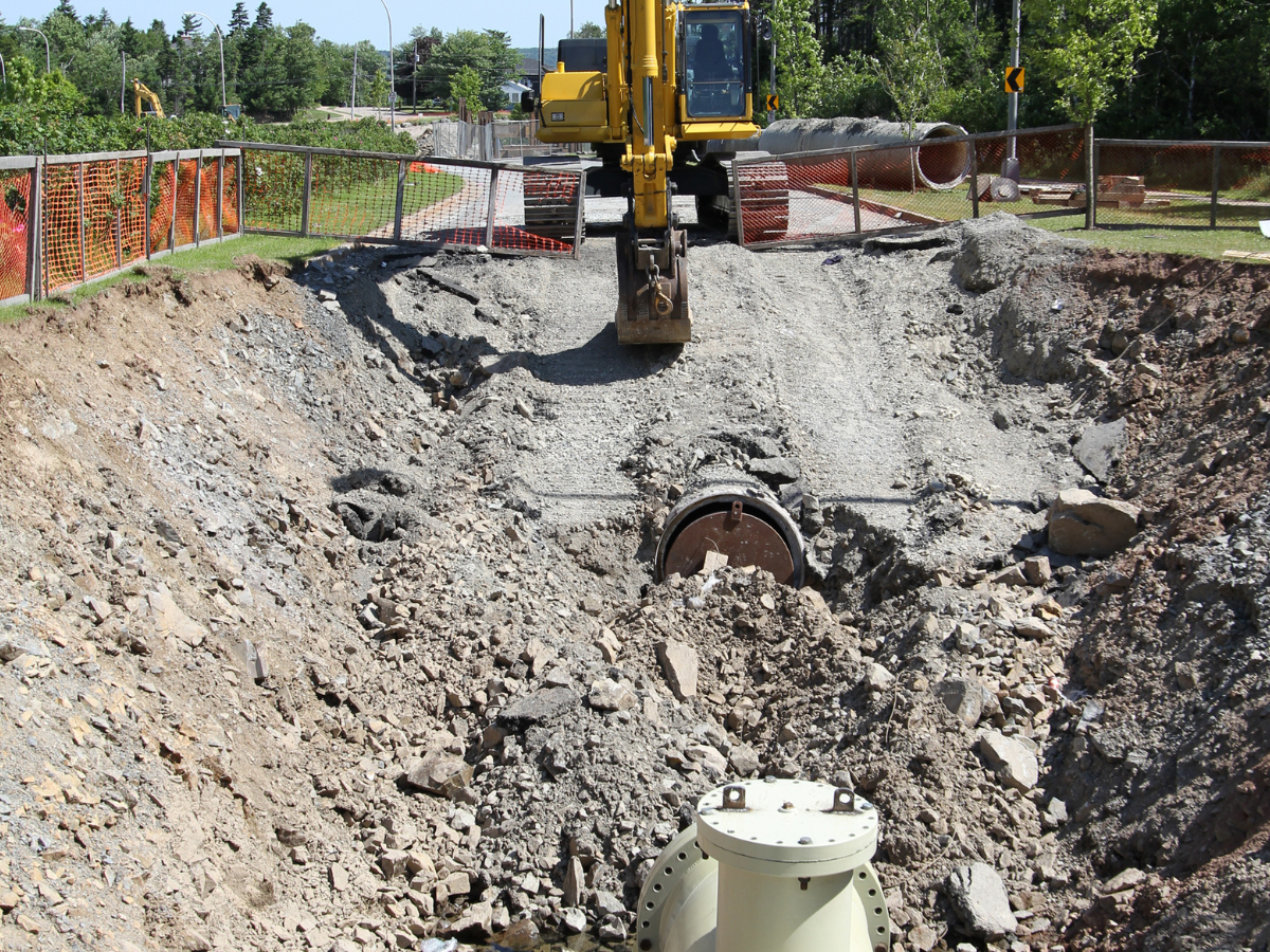 water main repair with back hoe digging